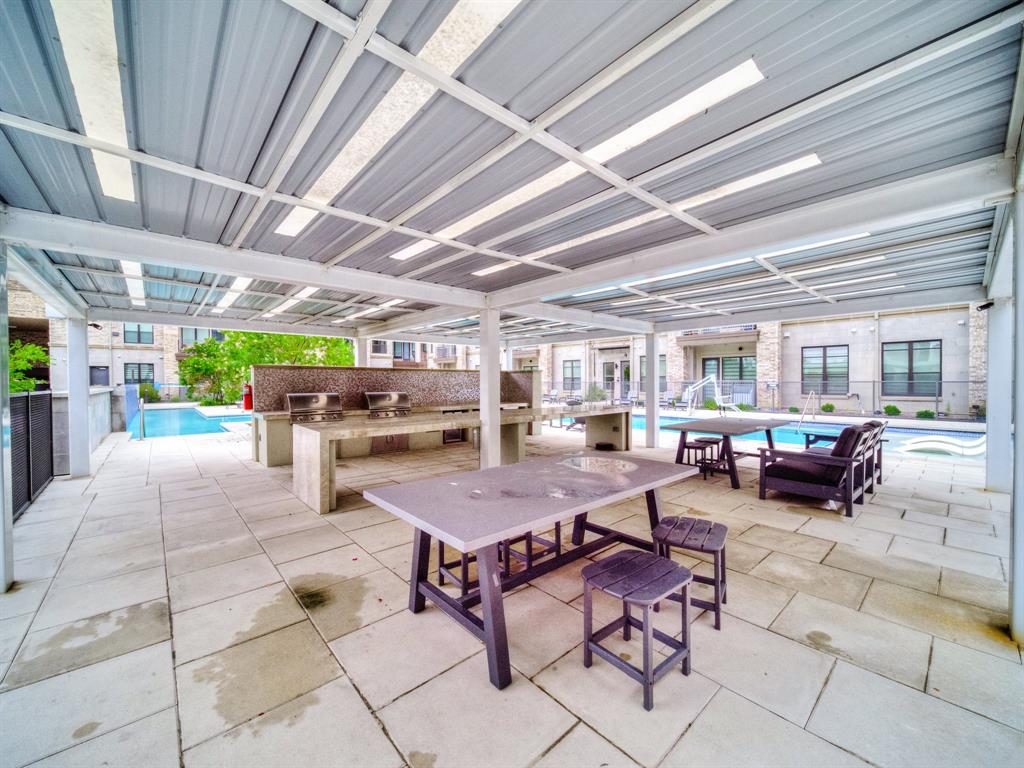 2700 Old Denton Road, Unit 2212 Carrollton, TX 75007 - Photo 36 of 38 Covered outdoor patio with a tiled floor, built-in grill stations, and a swimming pool