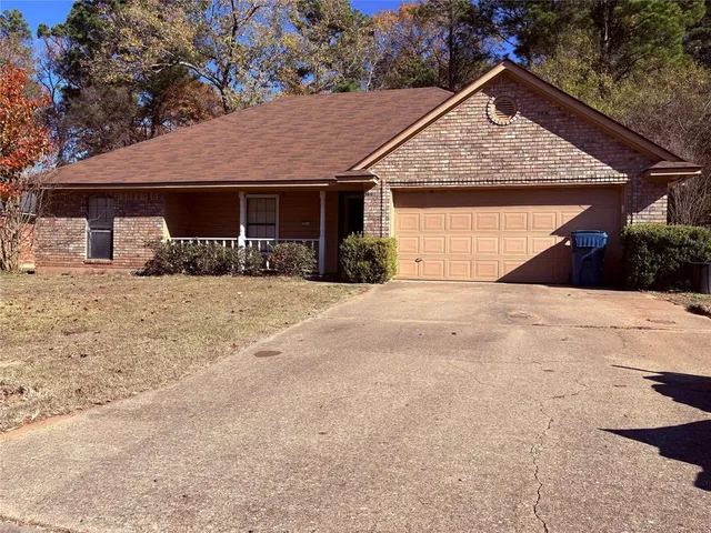 a front view of a house with a yard covered in snow