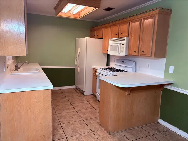 a kitchen with stainless steel appliances a sink a refrigerator and a stove