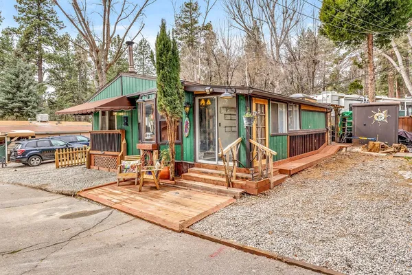 a view of a house with backyard and sitting area