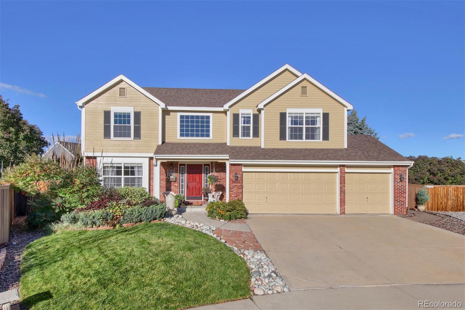 a front view of a house with yard and garage