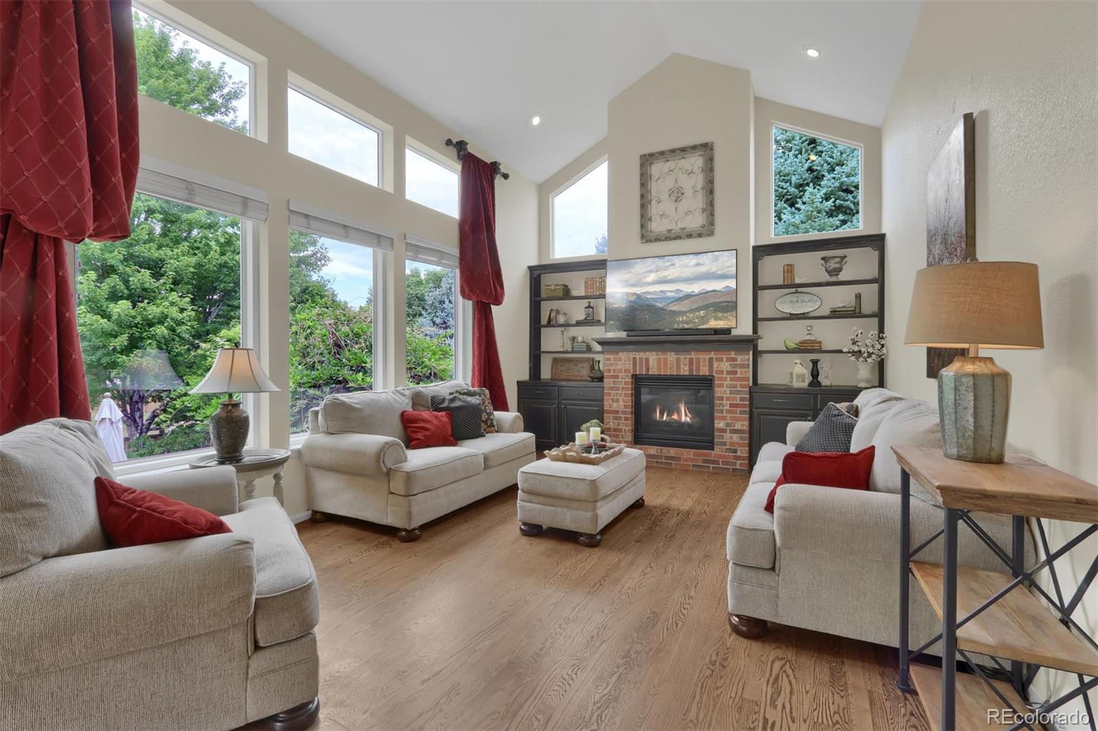 10115 Spring Water Court Highlands Ranch, CO 80129 - Photo 11 of 35 a living room with furniture fireplace and a large window
