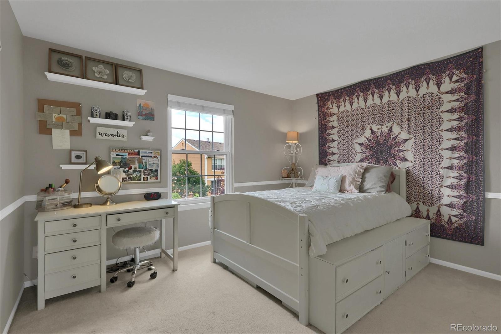 10115 Spring Water Court Highlands Ranch, CO 80129 - Photo 22 of 35 a spacious bedroom with a large bed and a window