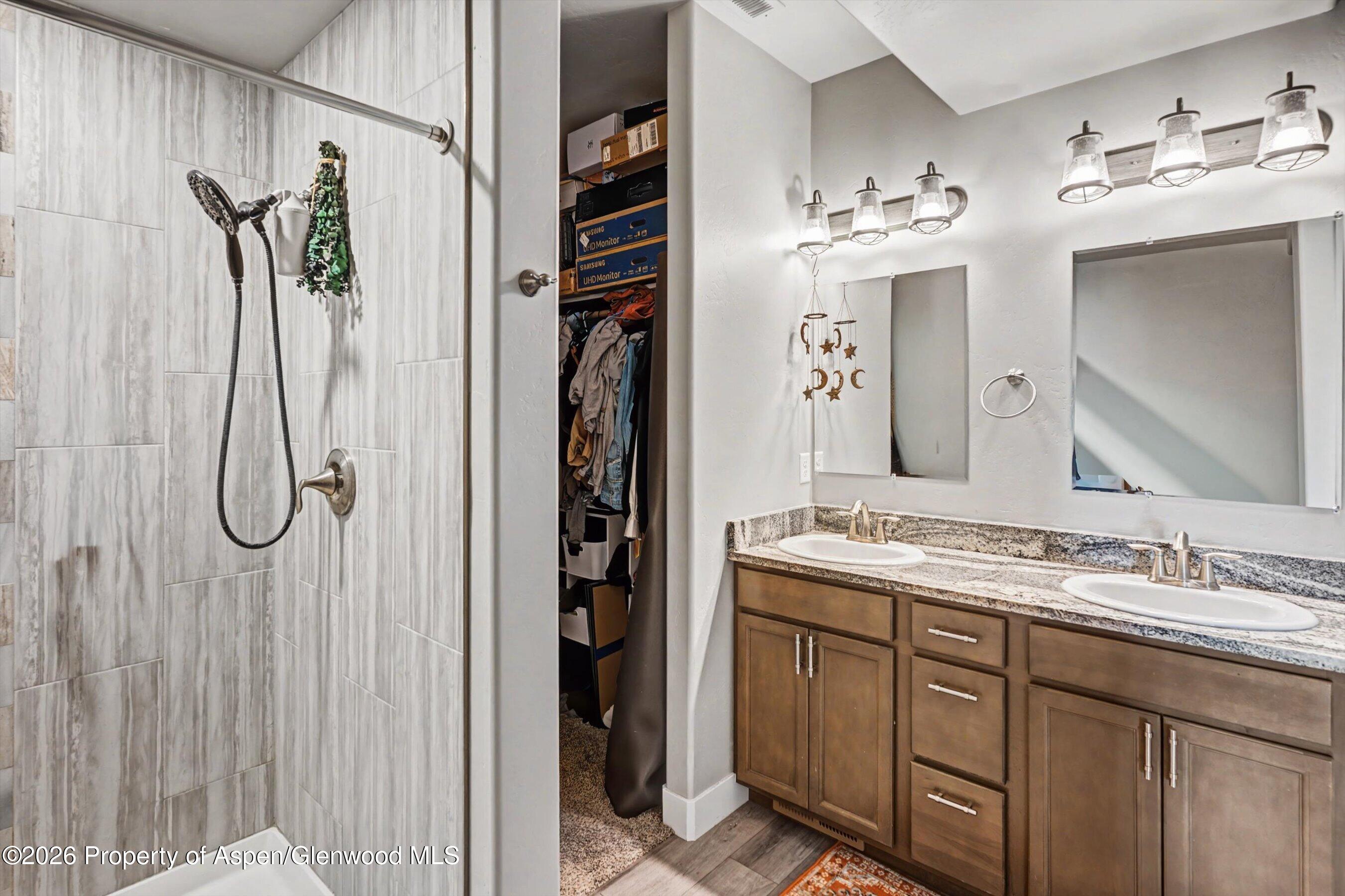 157 Willow Circle Rifle, CO 81650 - Photo 12 of 18 a bathroom with a double vanity sink mirror and shower
