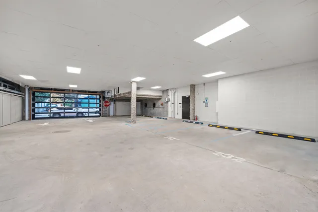a view of an empty room with a kitchen