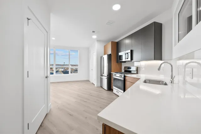 a large white kitchen with cabinets