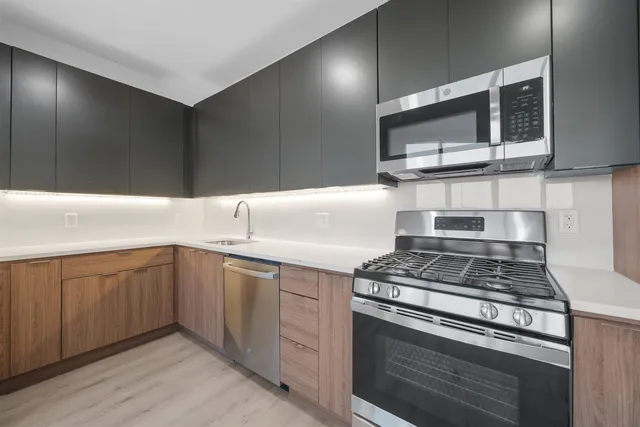 a kitchen with cabinets and steel stainless steel appliances