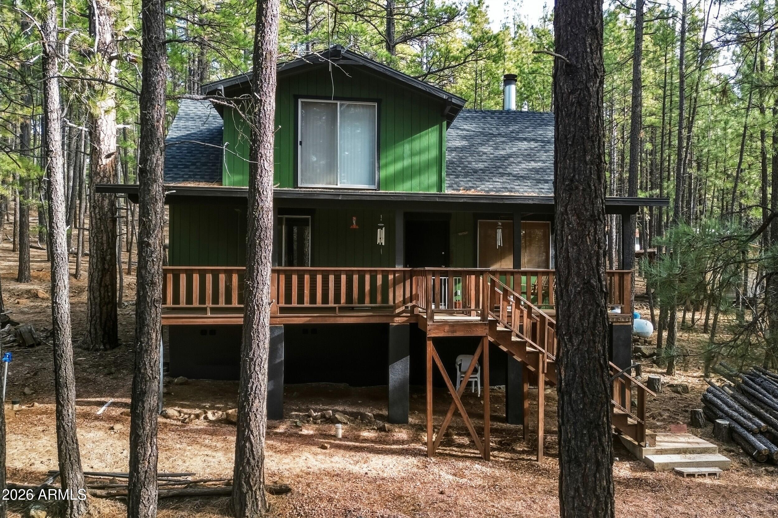 463 Long Valley Road Happy Jack, AZ 86024 - Photo 1 of 25 a view of a house with a porch