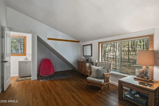 a living room with furniture a wooden floor and a table