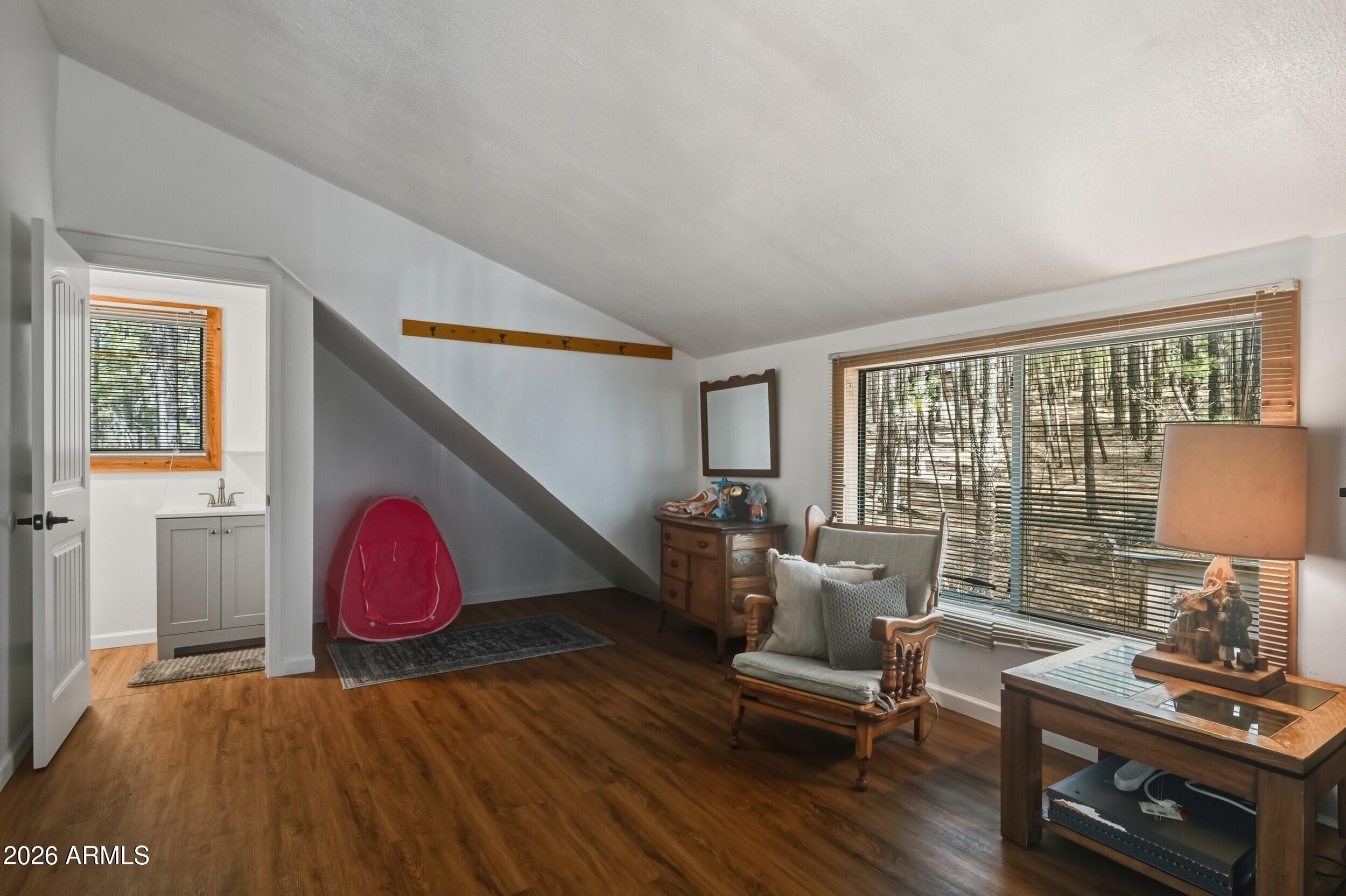 463 Long Valley Road Happy Jack, AZ 86024 - Photo 13 of 25 a living room with furniture a wooden floor and a table