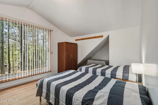 a bedroom with a bed and a large window