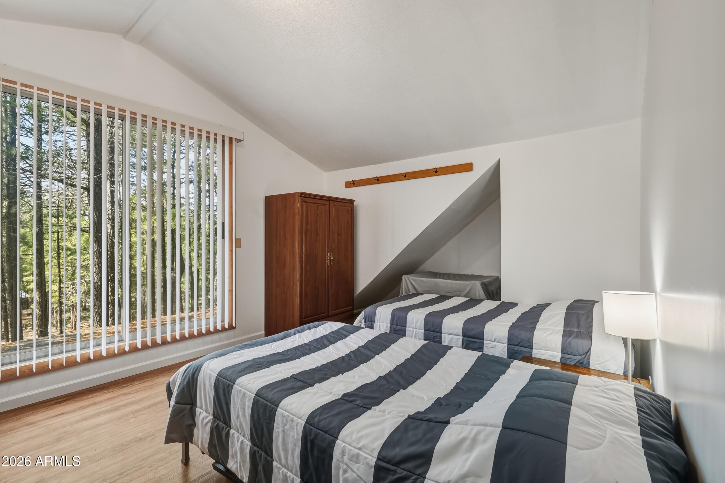 463 Long Valley Road Happy Jack, AZ 86024 - Photo 16 of 25 a bedroom with a bed and a large window