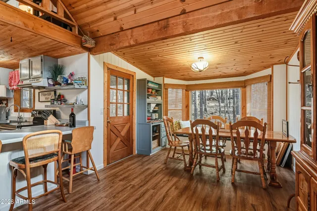 a dining room with furniture window and wooden floor