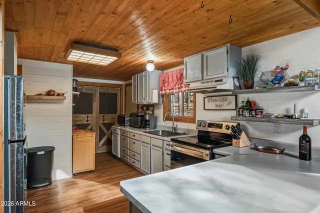 a kitchen with refrigerator and stove
