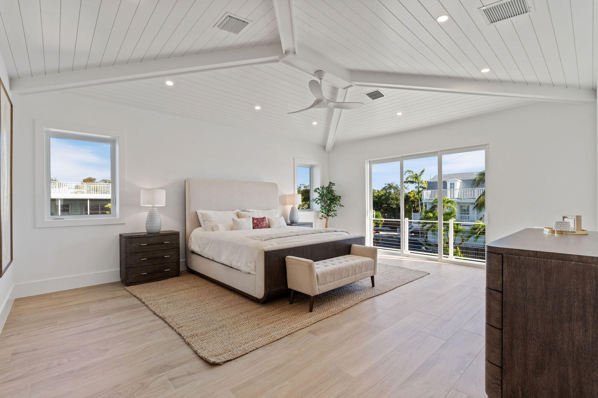 1002 Snapper Lane Key Largo, FL 33037 - Photo 21 of 106 a spacious bedroom with a bed and a chandelier