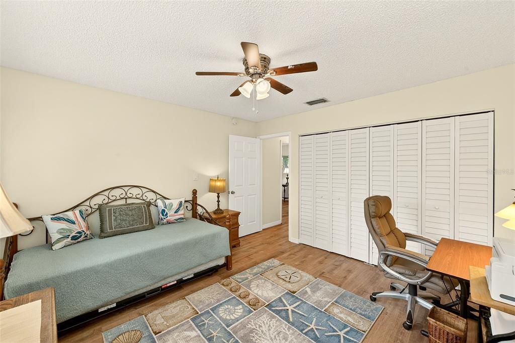 2064 Sunset Point Road, Unit 73 Clearwater, FL 33765 - Photo 30 of 58 a bedroom with furniture and a window