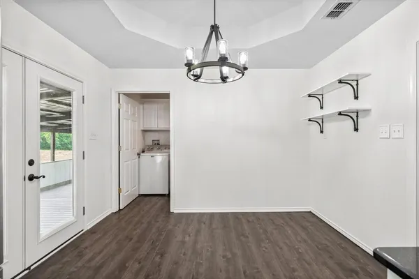 a view of a room with wooden floor