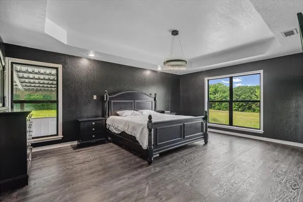a bedroom with a bed and a large window