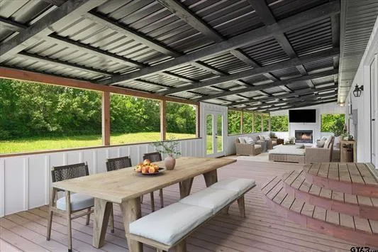 a view of a patio with lawn chairs and wooden floor