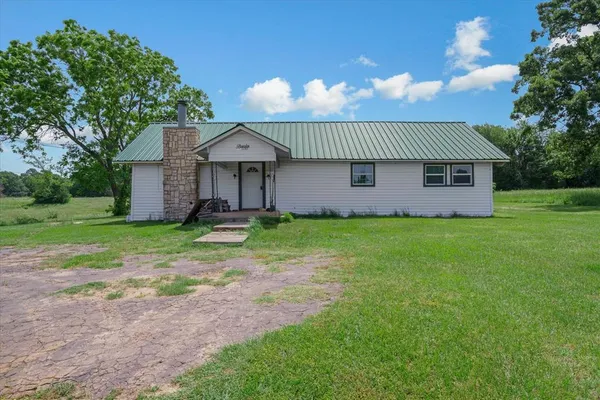 a front view of house with a garden