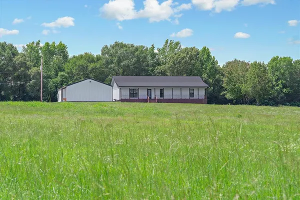 a view of a house with a backyard