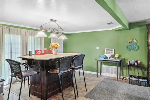 a view of a dining room with furniture and chandelier