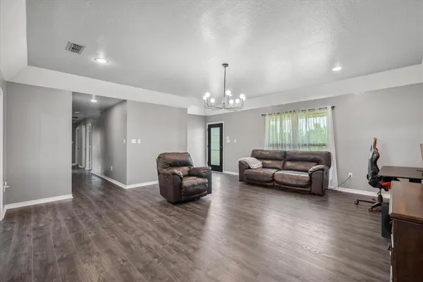 a living room with furniture and a chandelier