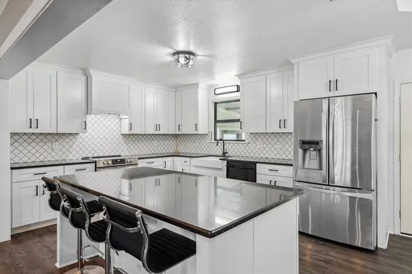 a kitchen with kitchen island a counter and stainless steel appliances