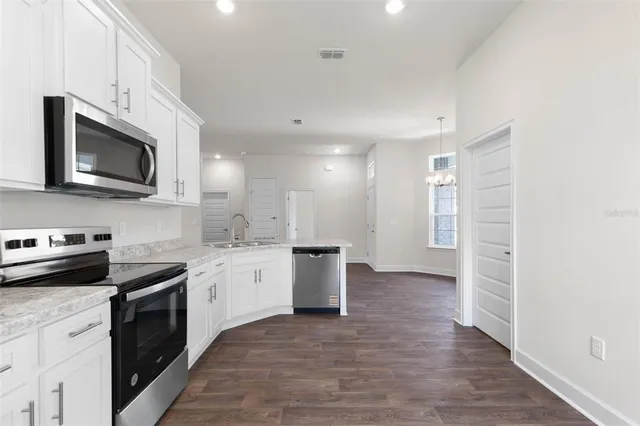 a kitchen with a sink stove and microwave