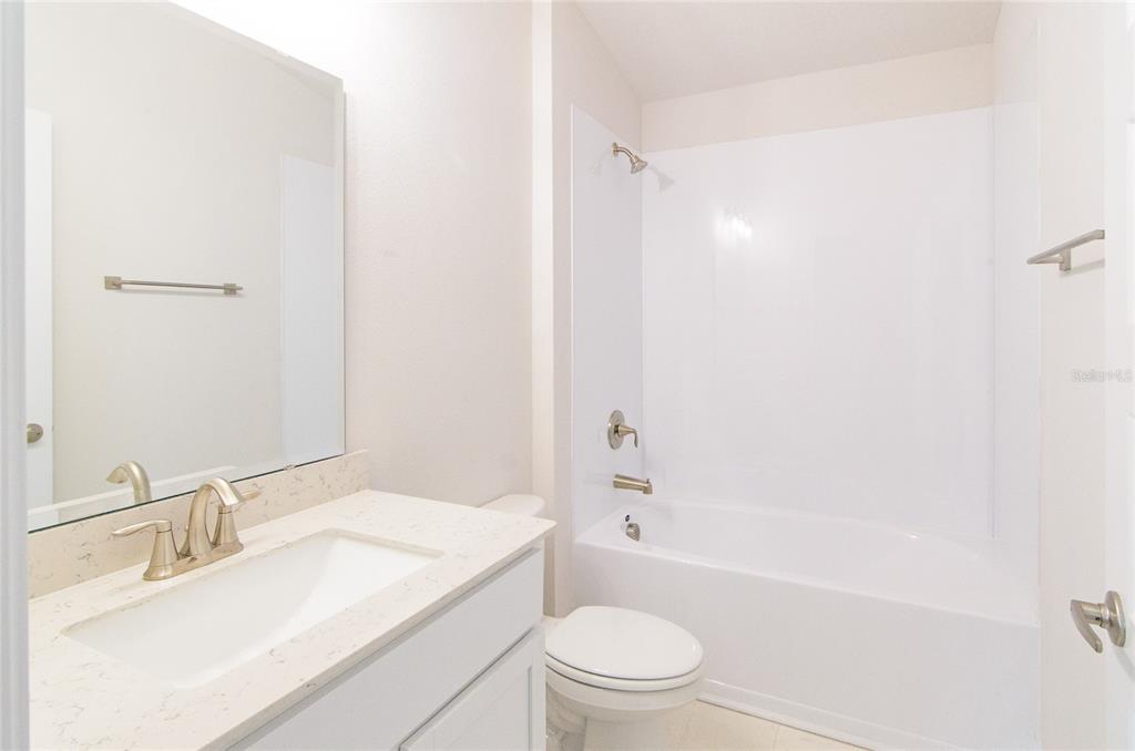 67 Sedgwick Trail Palm Coast, FL 32164 - Photo 18 of 27 a bathroom with a sink toilet vanity and shower