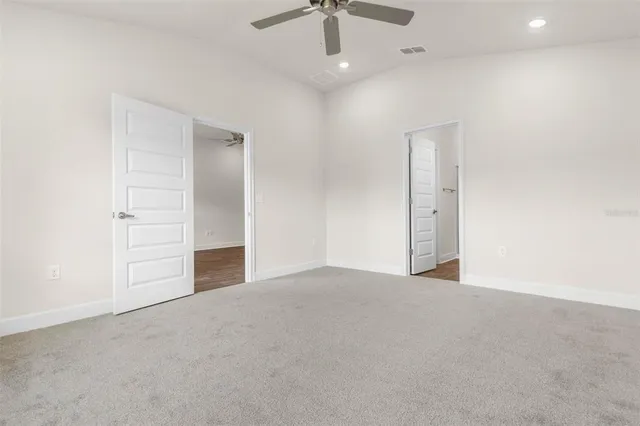 an empty room with a ceiling fan