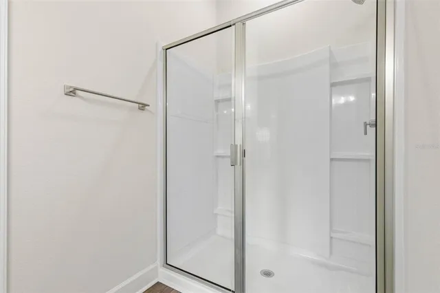 a bathroom with a glass shower door