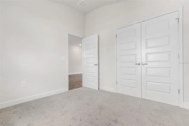 an empty room with closet area