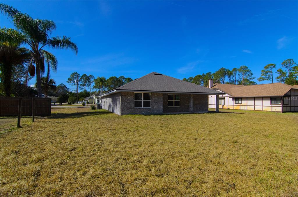 67 Sedgwick Trail Palm Coast, FL 32164 - Photo 26 of 27 a front view of a house with a yard