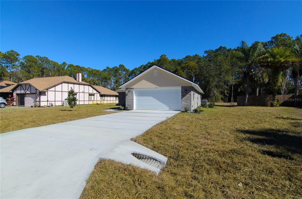 67 Sedgwick Trail Palm Coast, FL 32164 - Photo 4 of 27 a house view with a outdoor space