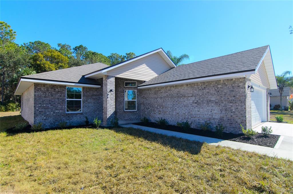 67 Sedgwick Trail Palm Coast, FL 32164 - Photo 6 of 27 a front view of a house with a yard