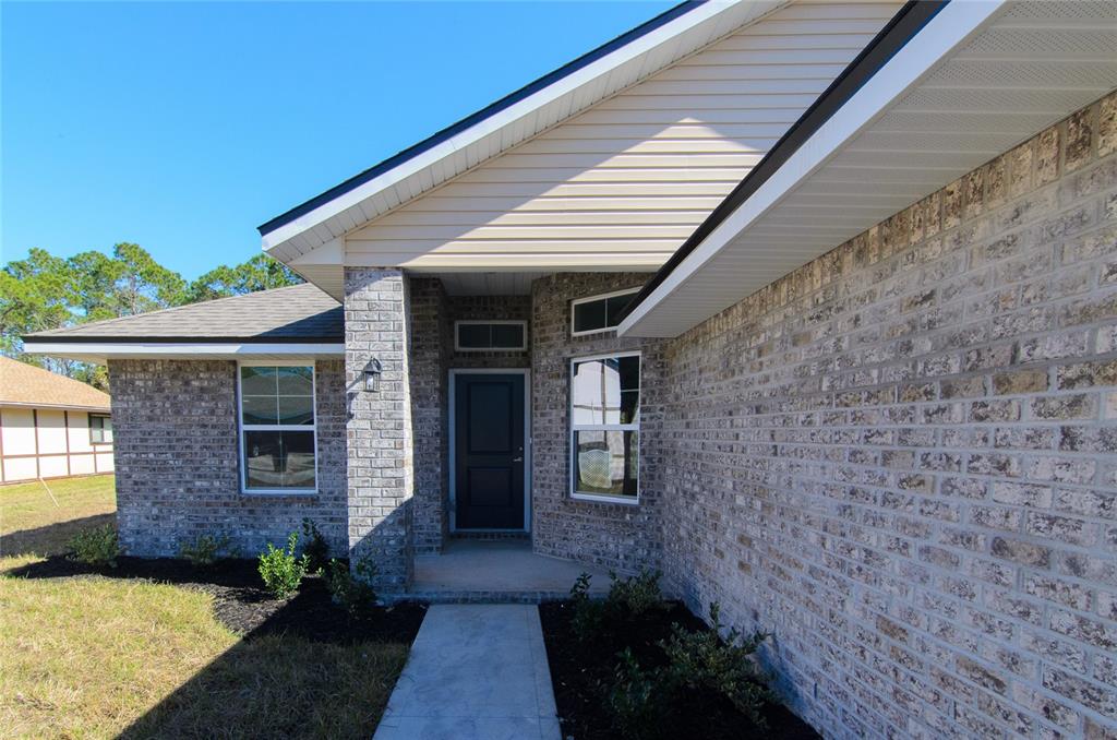 67 Sedgwick Trail Palm Coast, FL 32164 - Photo 7 of 27 a view of a brick house with a chairs