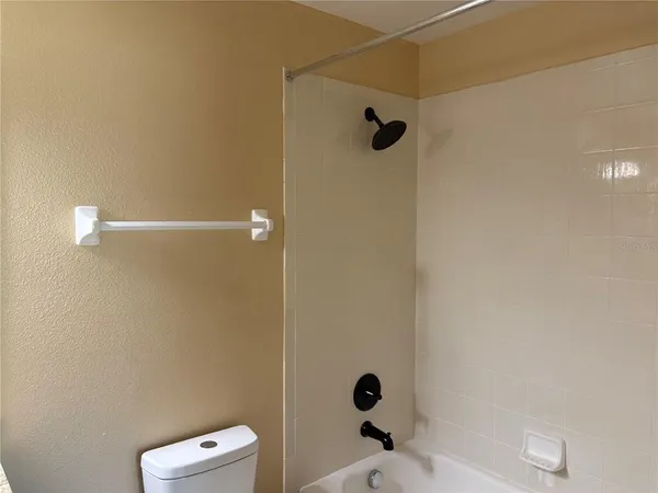 a bathroom with a shower and toilet