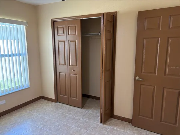 an empty room with closet area