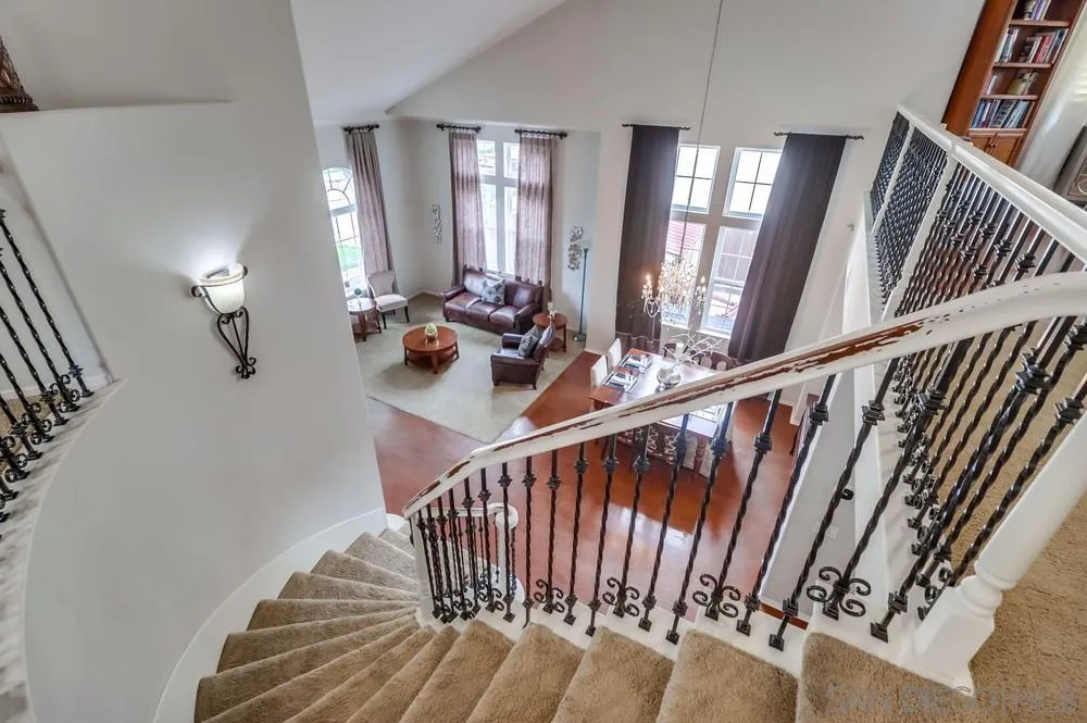 2567 View Trail Court Chula Vista, CA 91914 - Photo 20 of 55 a view of staircase with railing and a chandelier
