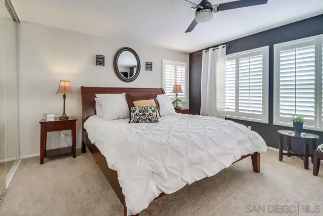 a bedroom with a bed and a table in it