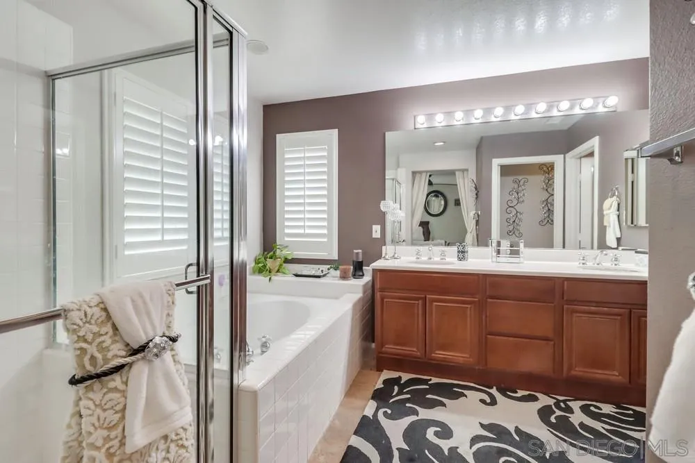 2567 View Trail Court Chula Vista, CA 91914 - Photo 29 of 55 a spacious bathroom with a tub sink and mirror