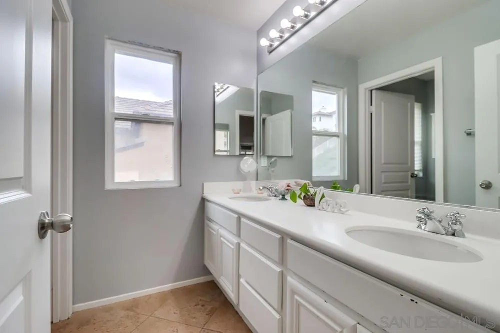 2567 View Trail Court Chula Vista, CA 91914 - Photo 30 of 55 a bathroom with a double vanity sink a mirror and window