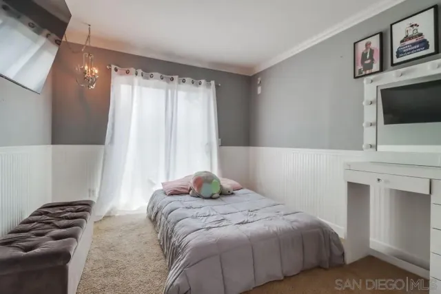 a bedroom with a bed dresser and a window