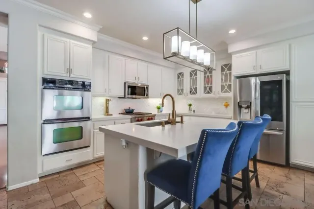 a kitchen with a sink microwave and refrigerator