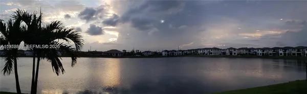 a living room with furniture a chandelier and a dining table