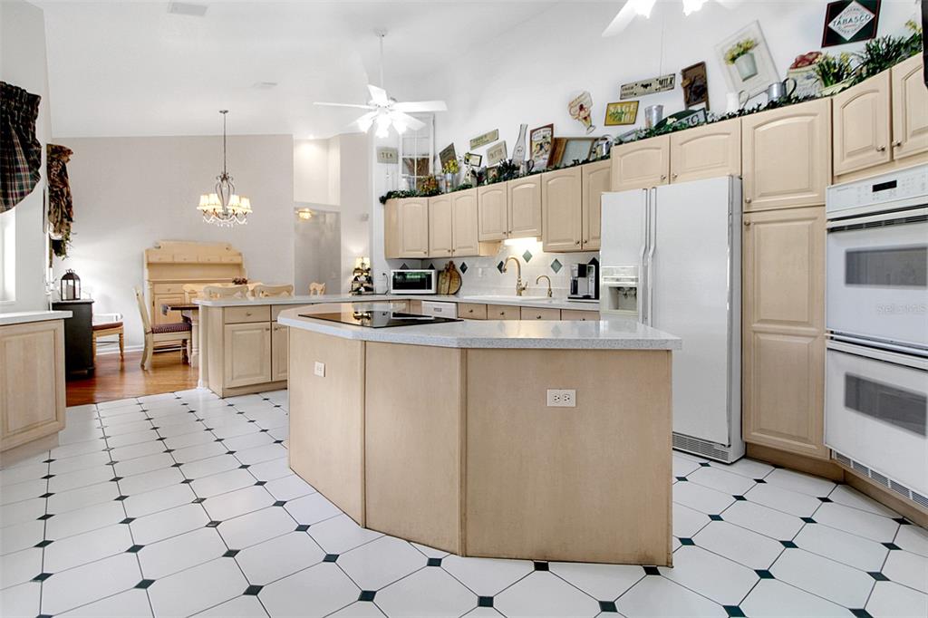 14481 Southwest 20th Street Davie, FL 33325 - Photo 16 of 36 a kitchen with stainless steel appliances a sink a stove a refrigerator and cabinets