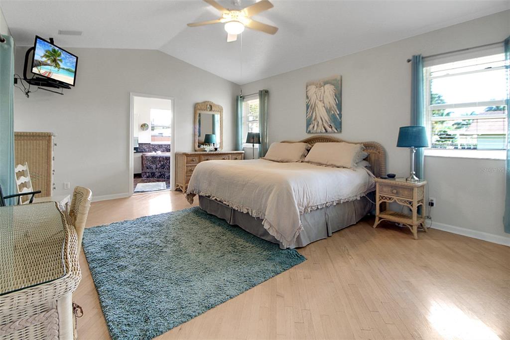 14481 Southwest 20th Street Davie, FL 33325 - Photo 23 of 36 a spacious bedroom with a bed a table and chair