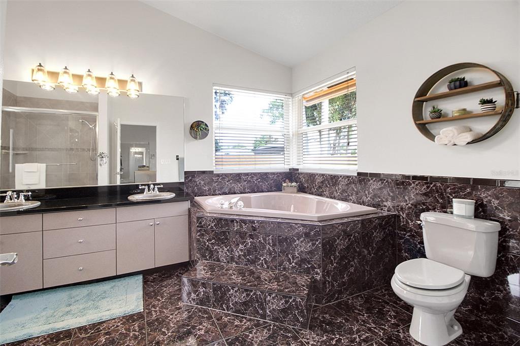 14481 Southwest 20th Street Davie, FL 33325 - Photo 25 of 36 a bathroom with a double vanity sink and a bathtub