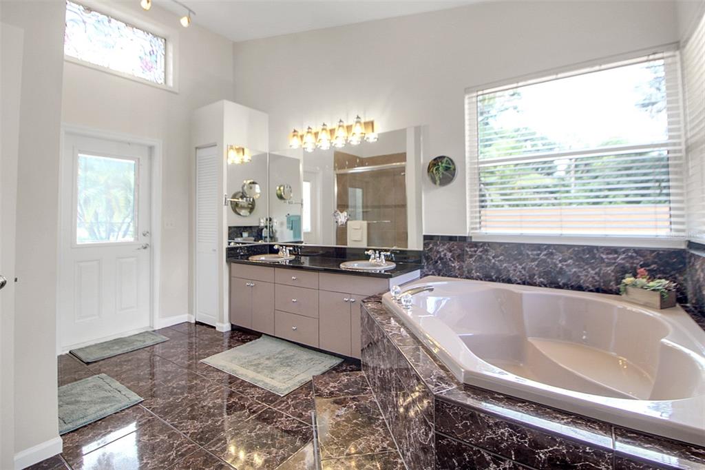 14481 Southwest 20th Street Davie, FL 33325 - Photo 26 of 36 a spacious bathroom with a bathtub and a sink